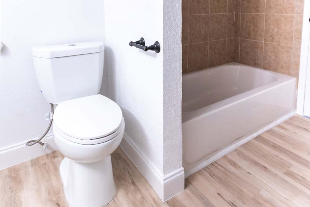 Bathroom with tub at Lakeshore Villa Apartments in Rowlett,Texas