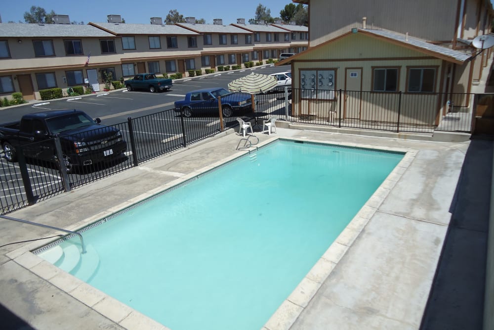 Resort-style swimming pool at Olympus Court Apartments in Bakersfield, California