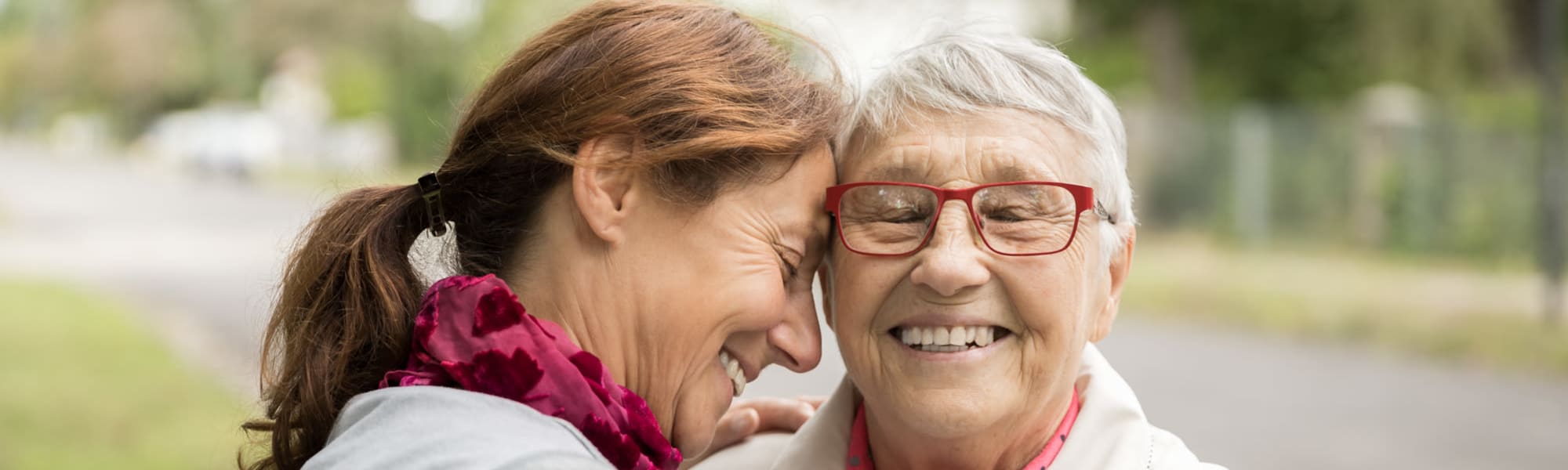 caretaker and resident hugging at The Blake at LPGA building in Daytona Beach, Florida