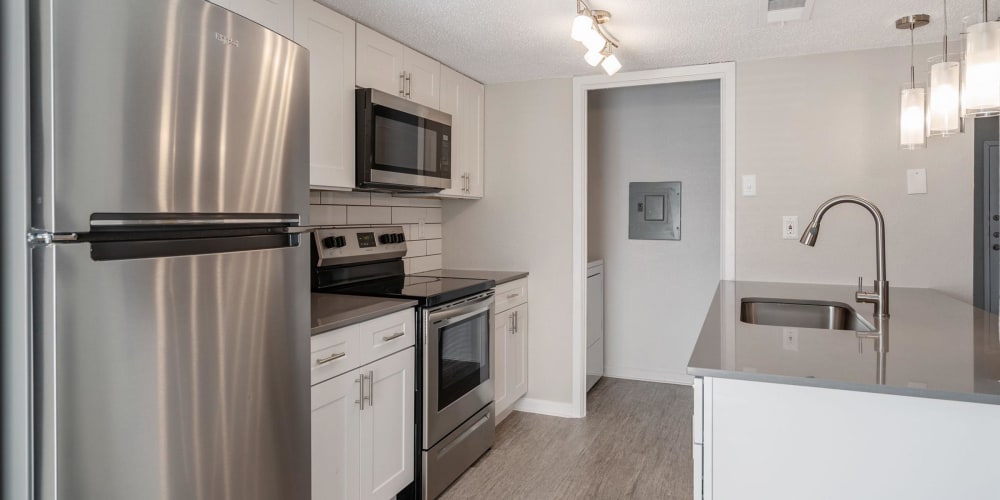 Kitchen with stainless-steel appliances at Tides on Green Oaks in Arlington, Texas