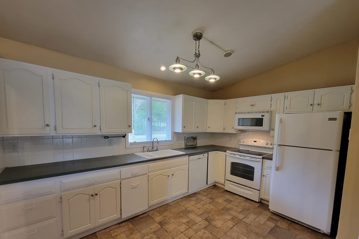 White cupboards in a home's kitchen at Traditional Housing in Cedar Falls, Iowa