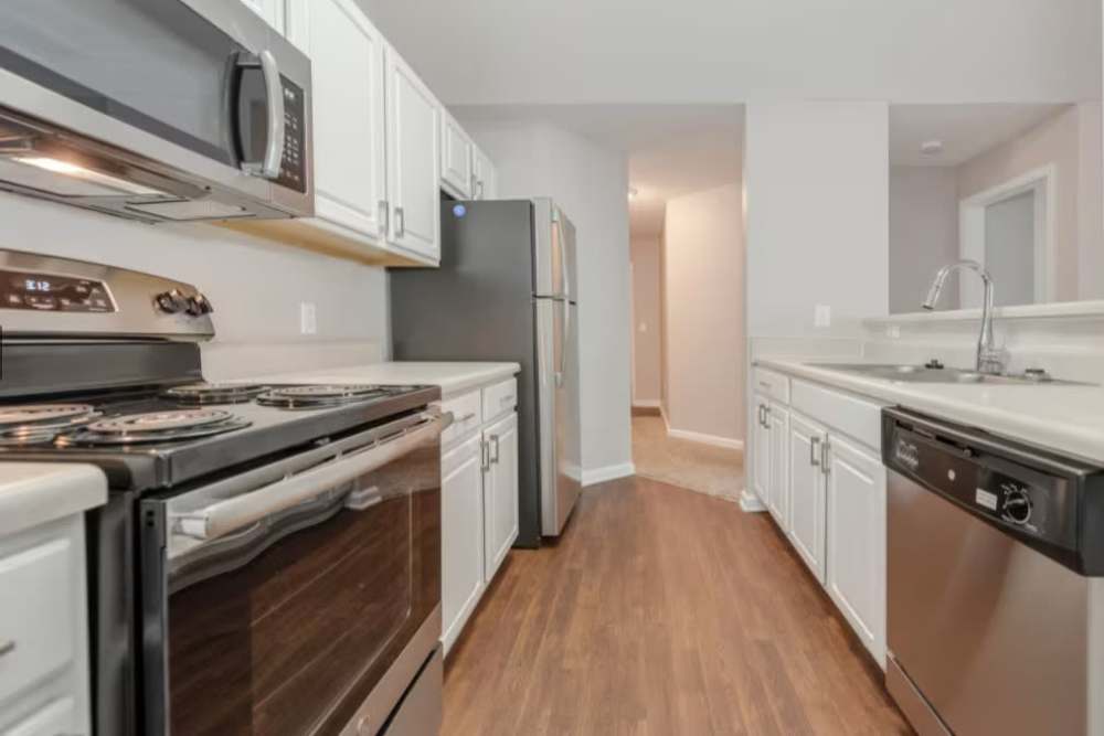 Kitchen with black appliances at Arbors at Fairview Apartments in Simpsonville, South Carolina