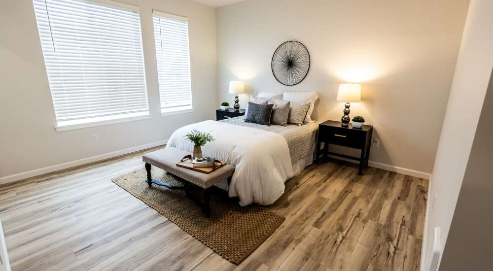 Bright bedroom with large windows with wood-style flooring at 4315 S. Alder in Tacoma, Washington