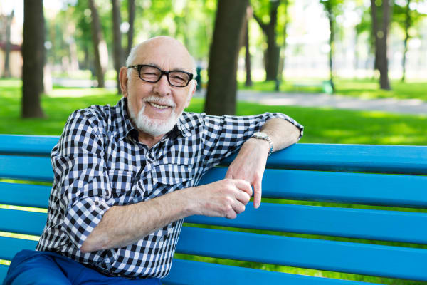 Resident enjoying a park bench at Merrill Gardens at Hillsboro in Hillsboro, Oregon. 