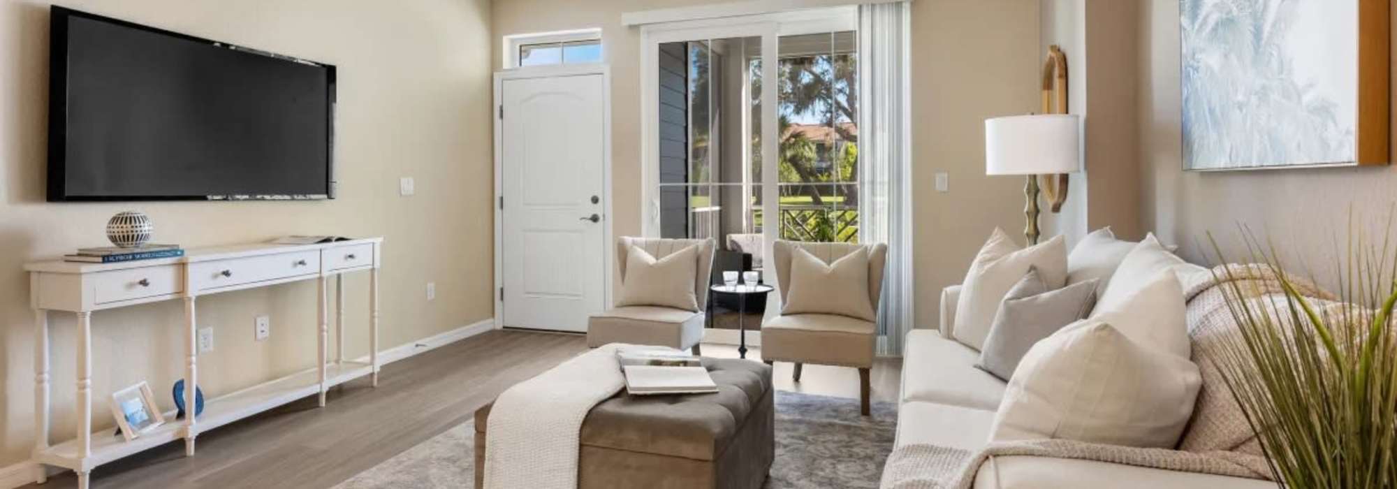 Living room with television at The Residences at Creighton Waterway in North Port, Florida