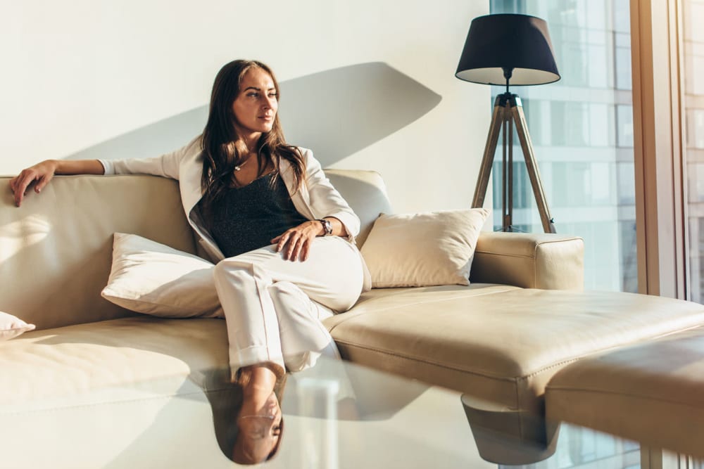 Resident sitting on couch at Transcendent Electra in Bay Harbor Island, Florida