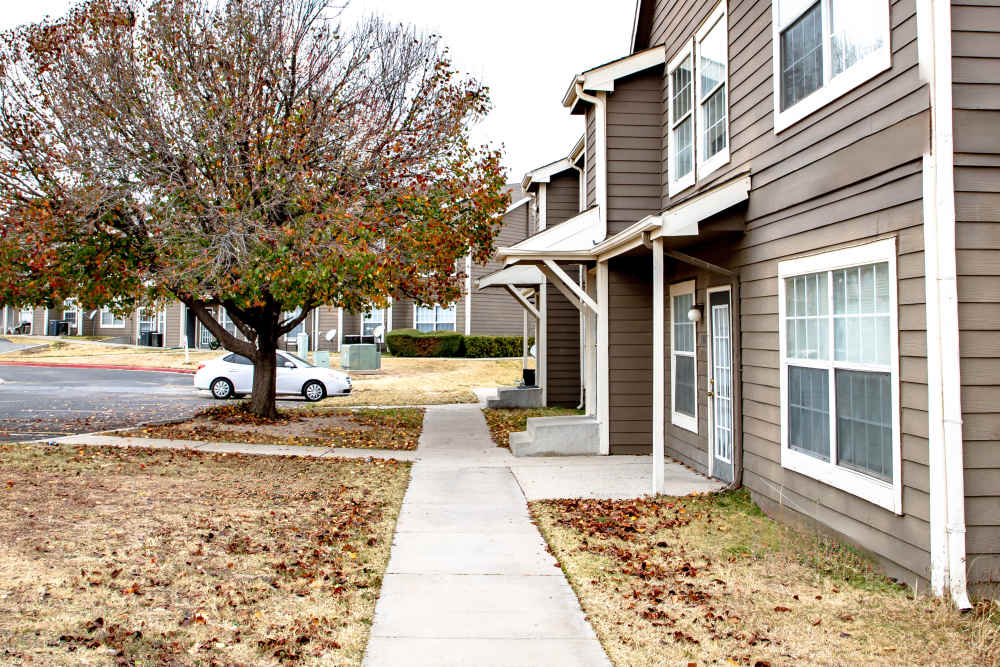Building exterior with walkway at Whispering Plains Apartments in Guymon, Oklahoma
