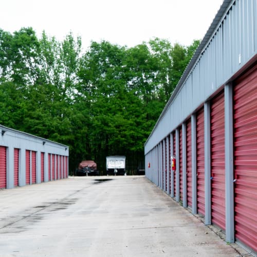 Storage units and outdoors boat and RV parking with wide driveways at Red Dot Storage in Denham Springs, Louisiana