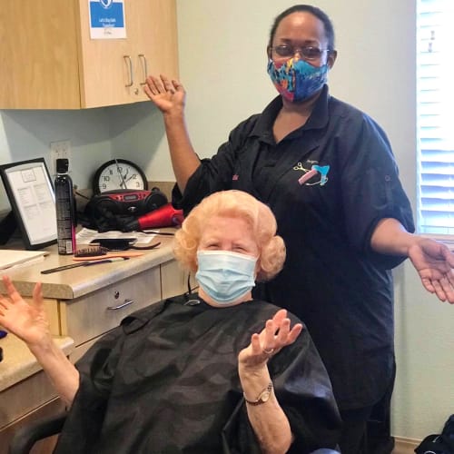 Resident sitting and smiling at Oxford Glen Memory Care at Carrollton in Carrollton, Texas