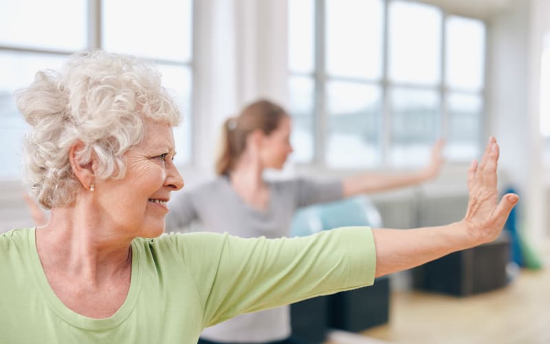 Residents exercising in the gym at a The Commons on Thornton community