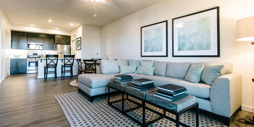 Living room and kitchen with wood-style flooring at Garnet Creek in Rocklin, California