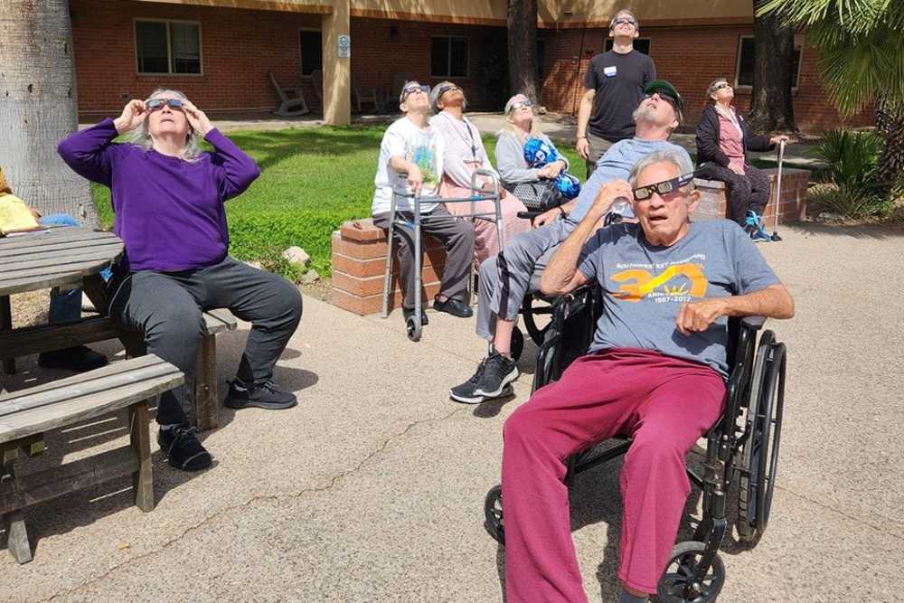 People wearing sun glasses outside at Woodland Palms Memory Care in Tucson, Arizona