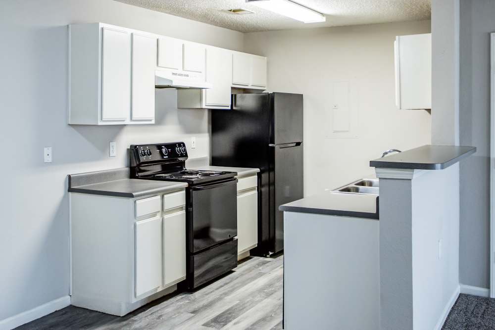 Kitchen with stainless-steel appliances at Whispering Plains Apartments in Guymon, Oklahoma