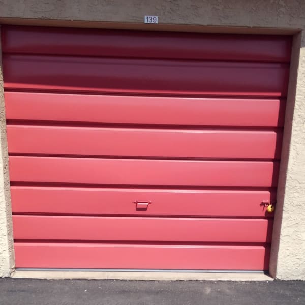 Outdoor storage unit with a red door at StorQuest Self Storage in Phoenix, Arizona