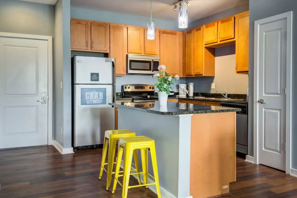 Bright eat-in kitchen with wooden cabinets at The Landing at St. Louis in Saint Louis, Missouri