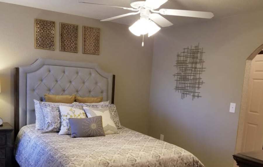Spacious bedroom with large bed and ceiling fan at The Reserve at Kanapaha in Gainesville, Florida