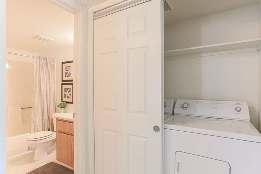 Bathroom with attached washer and dryer at Ashford Park in Sacramento, California