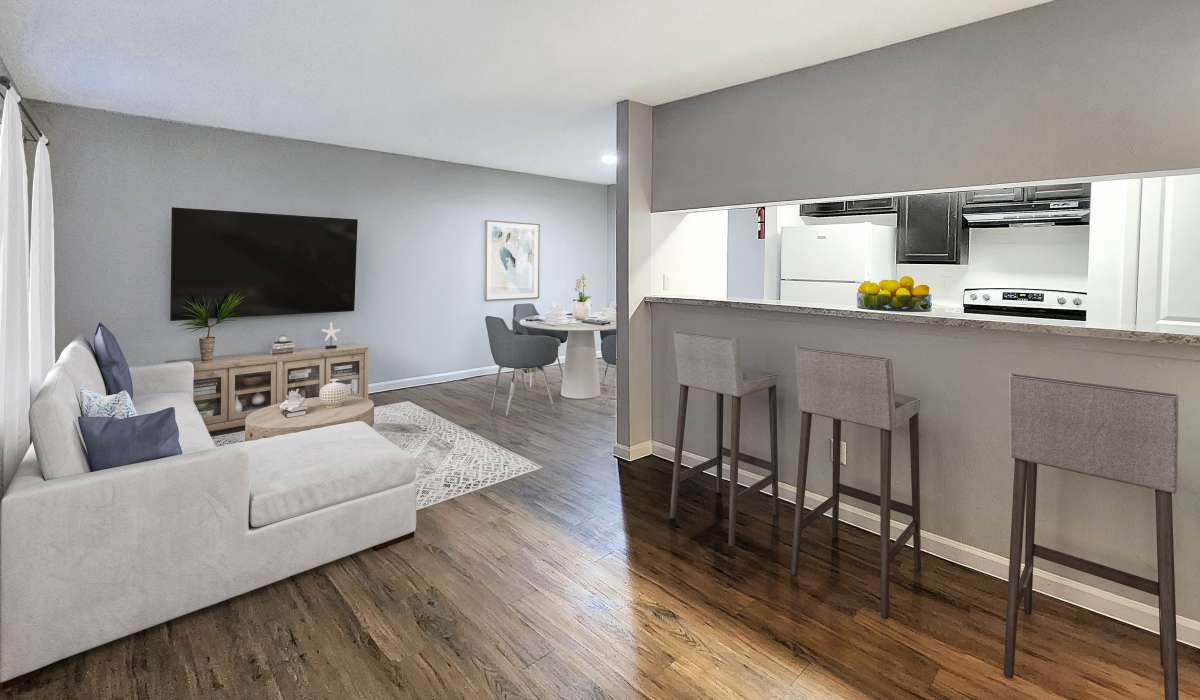 Living room with connecting kitchen at Costa Mesa Apartments in Houston, Texas