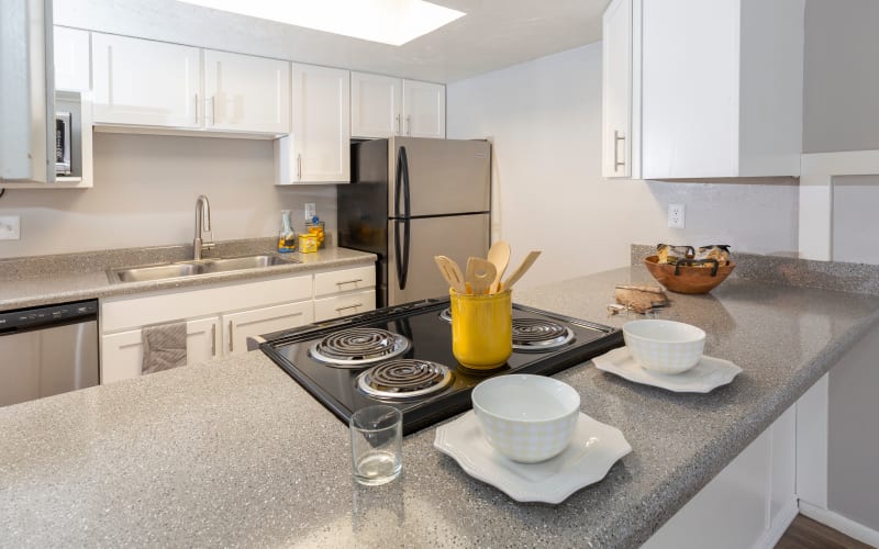 Renovated kitchen with white cabinets and ample counter space at Windgate Apartments in Bountiful, Utah
