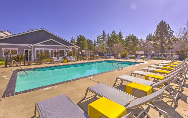 Seating near the swimming pool on a sunny day at Cascade Ridge in Silverdale, Washington