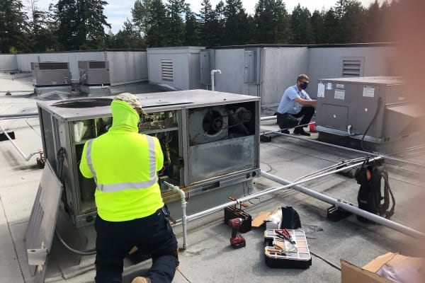 Workers installing an HVAC at  Patriots Landing in DuPont, Washington. 