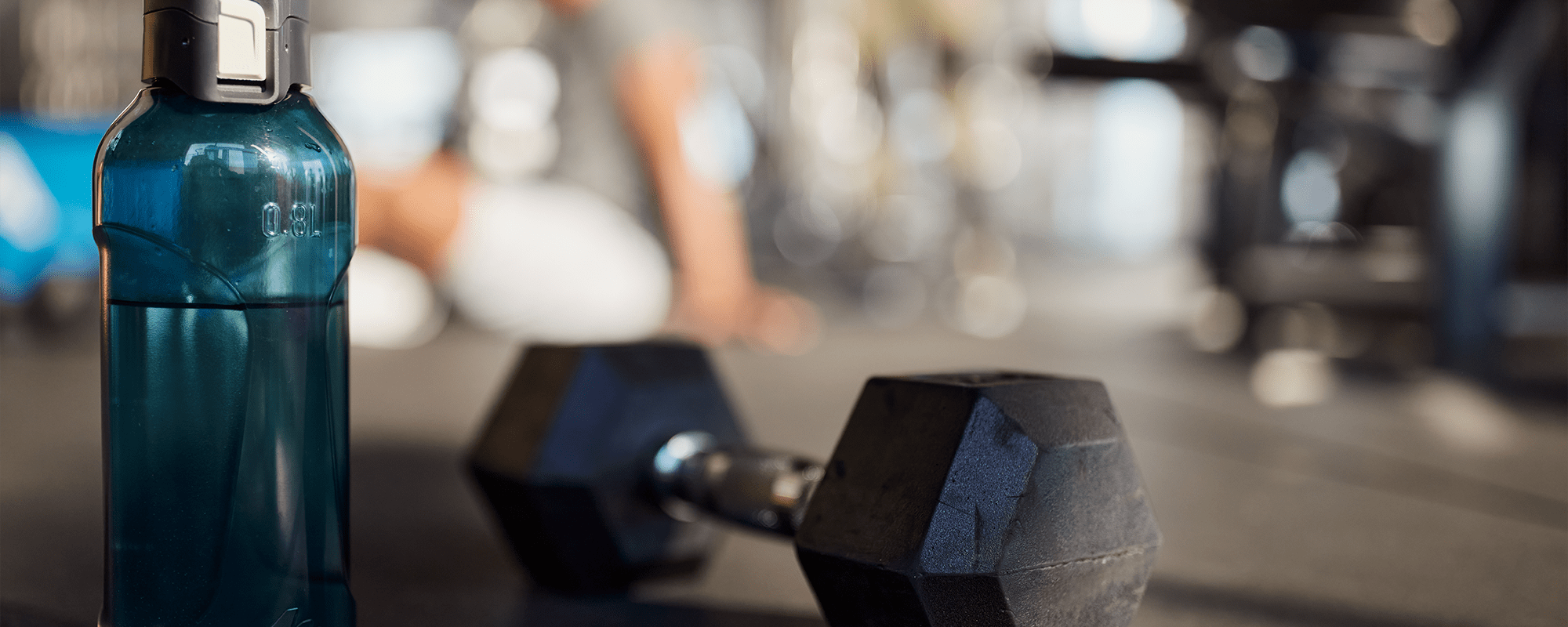 Three people doing yoga in fitness center at Residences at 111 Lyon in Grand Rapids, Michigan