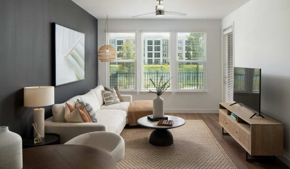 Spacious living room with couch and flat-screen TV at Afton Palms in Sanford, Florida, 