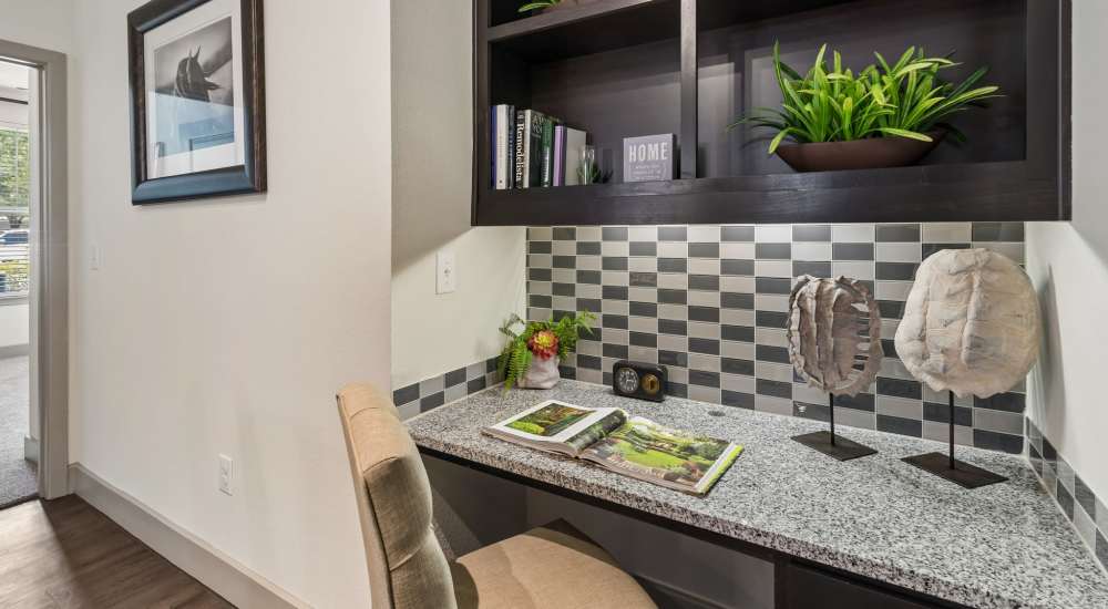 Modern desk space with granite countertops and shelving at Plantation Park Apartments in Lake Jackson, Texas
