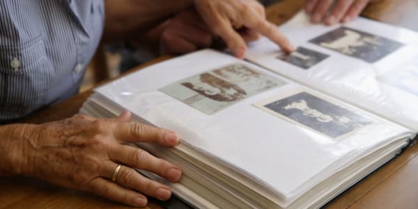 Resident looking through a photo album at Maple Ridge Care Center in Spooner, Wisconsin