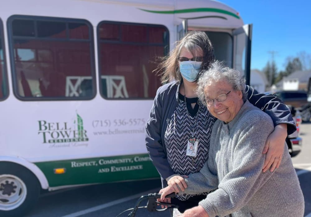 Resident next to transport bus at Bell Tower Residence Assisted Living in Merrill, Wisconsin