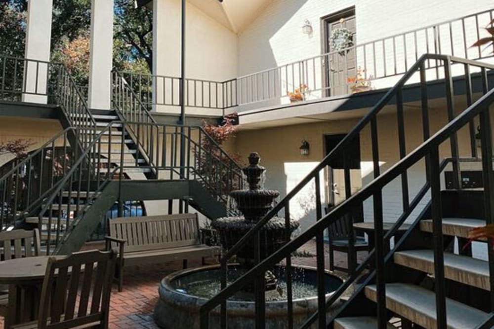 brick courtyard with fountain and furniture at The Fountains of Preston Hollow in Dallas, Texas