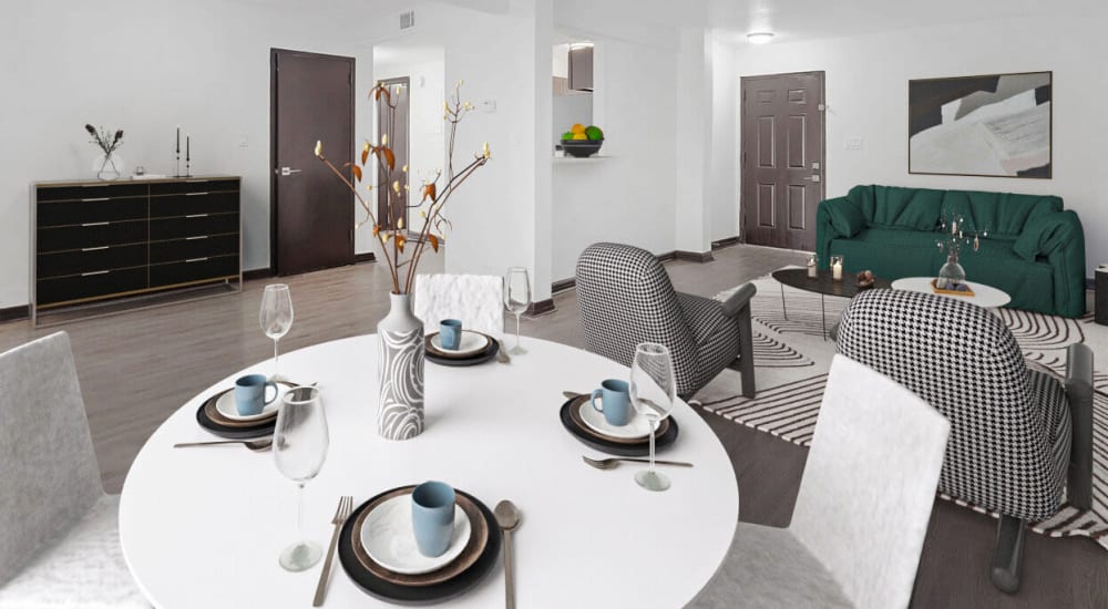 Spacious interior living room with a dining table and couches in a model home at The Overlook at Pensacola Bay in Pensacola, Florida