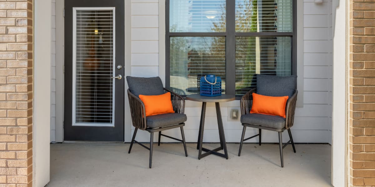 Private balcony with chairs and side table at Marq at Crabtree in Raleigh, North Carolina