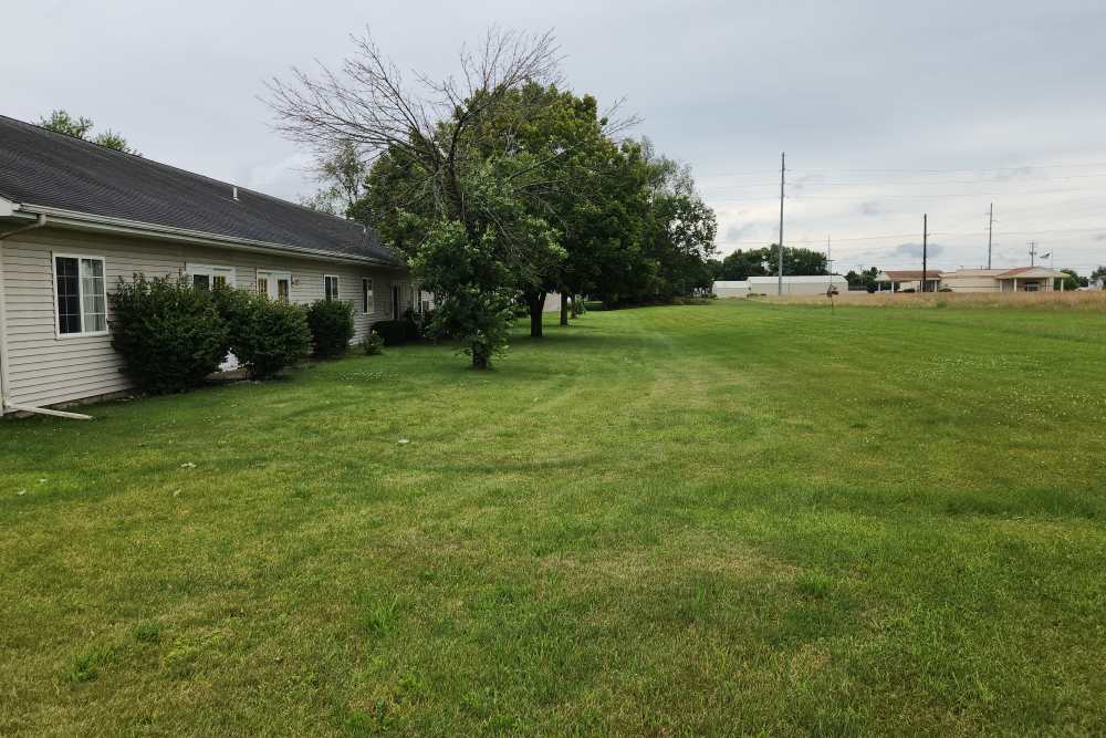 Lush landscaping at Woodbrook Apartments in Three Rivers, Michigan