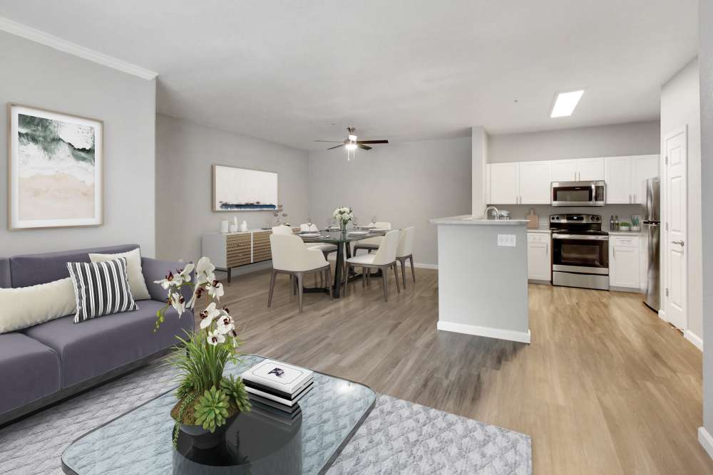A kitchen and spacious living with dining area at Natomas Park Apartments in Sacramento, California