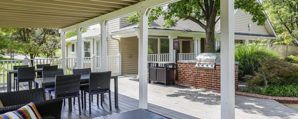 Comfortable, covered outdoor seating in a grilling area at Springwoods at Lake Ridge in Woodbridge, Virginia