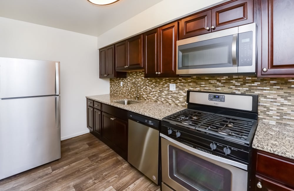 A kitchen with stainless-steel appliances in a home at Brookside Manor Apartments & Townhomes in Lansdale, Pennsylvania