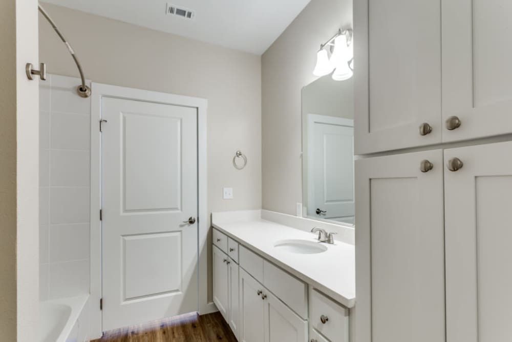 Bathroom with shower and double storage vanity at The Trail Lakes in Fort Worth, Texas