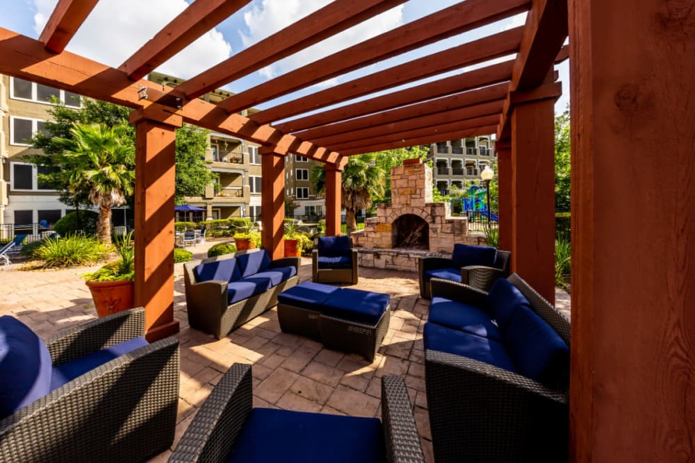 Colorful patio furniture with fireplace under gazebo at Marquis at Stone Oak in San Antonio, Texas
