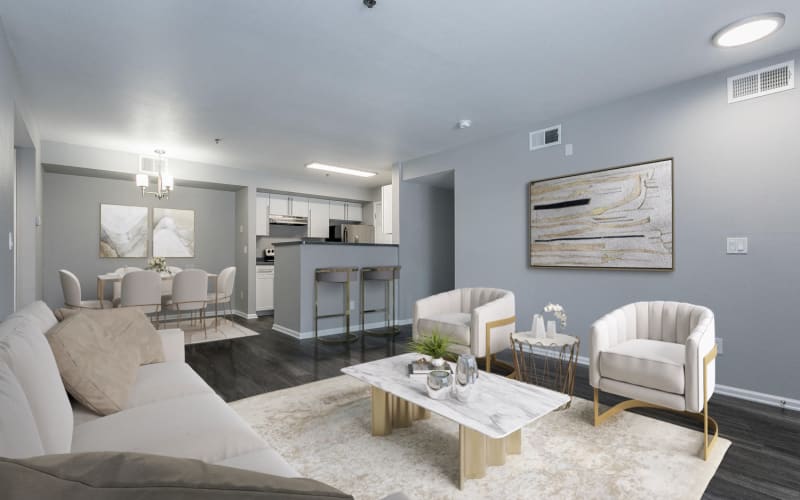 Spacious Living Room with View of Dining Room and White Renovated Cabinetry Kitchen at Tuscany Village Apartments in Ontario, California