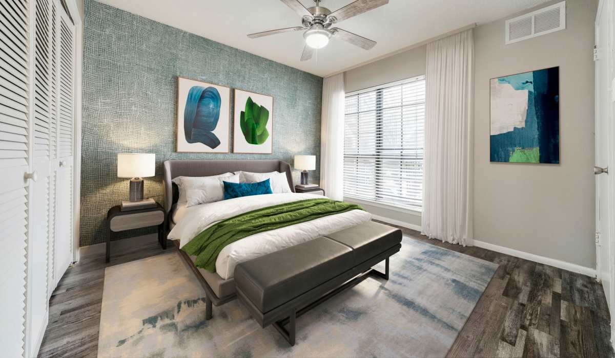 Bedroom with a large bed and windows at Icon Apartments in San Antonio, Texas
