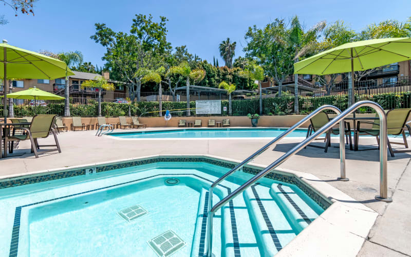 The sparkling swimming pool and hot tub on a sunny day at Hillside Terrace Apartments in Lemon Grove, California