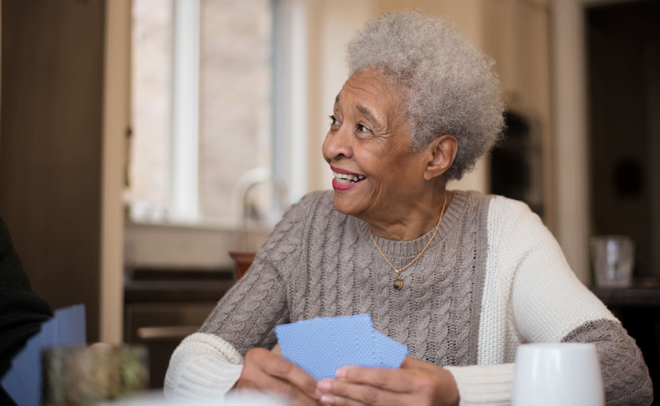 A resident playing cards at Truewood by Merrill, Cottonwood Heights in Cottonwood Heights, Utah. 