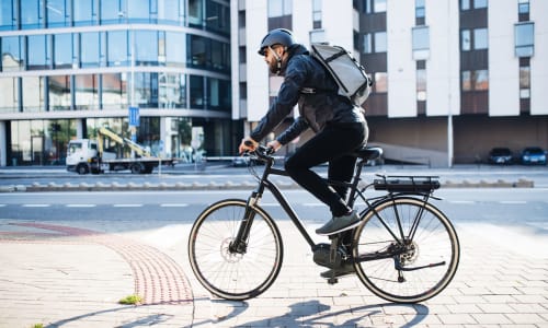 Man biking near Sycamore Commons Apartments in Fremont, California