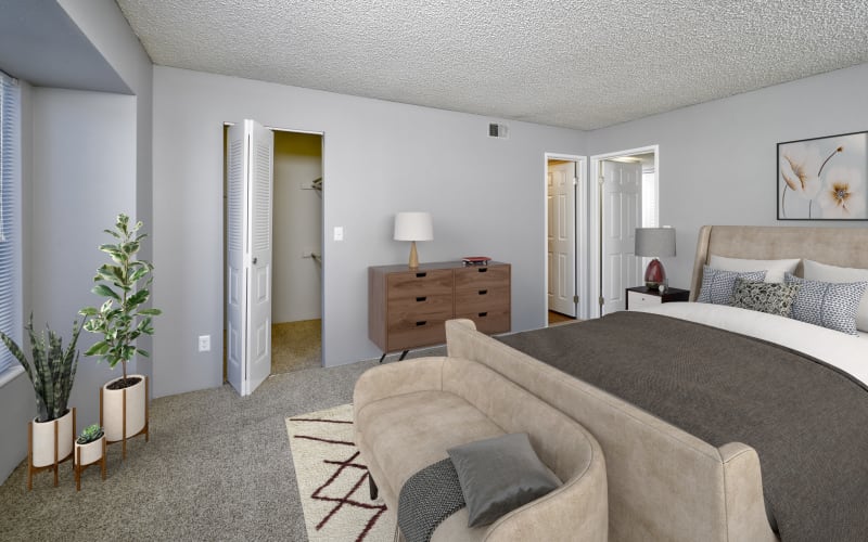 Spacious master bedroom with plush carpeting at Alton Green Apartments in Denver, Colorado