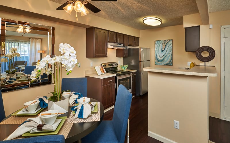 Espresso cabinets in the kitchen overlooking the dining room at Alton Green Apartments in Denver, Colorado