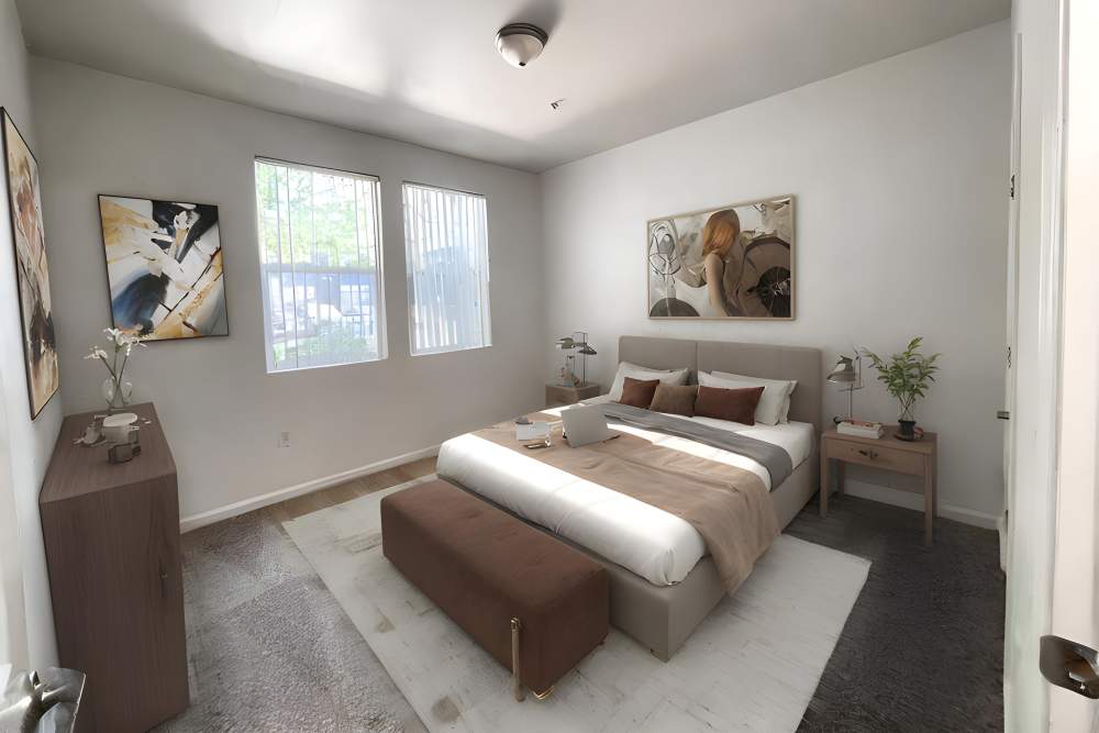 Master bedroom with a large window for natural lighting at The Lofts in Sacramento, California