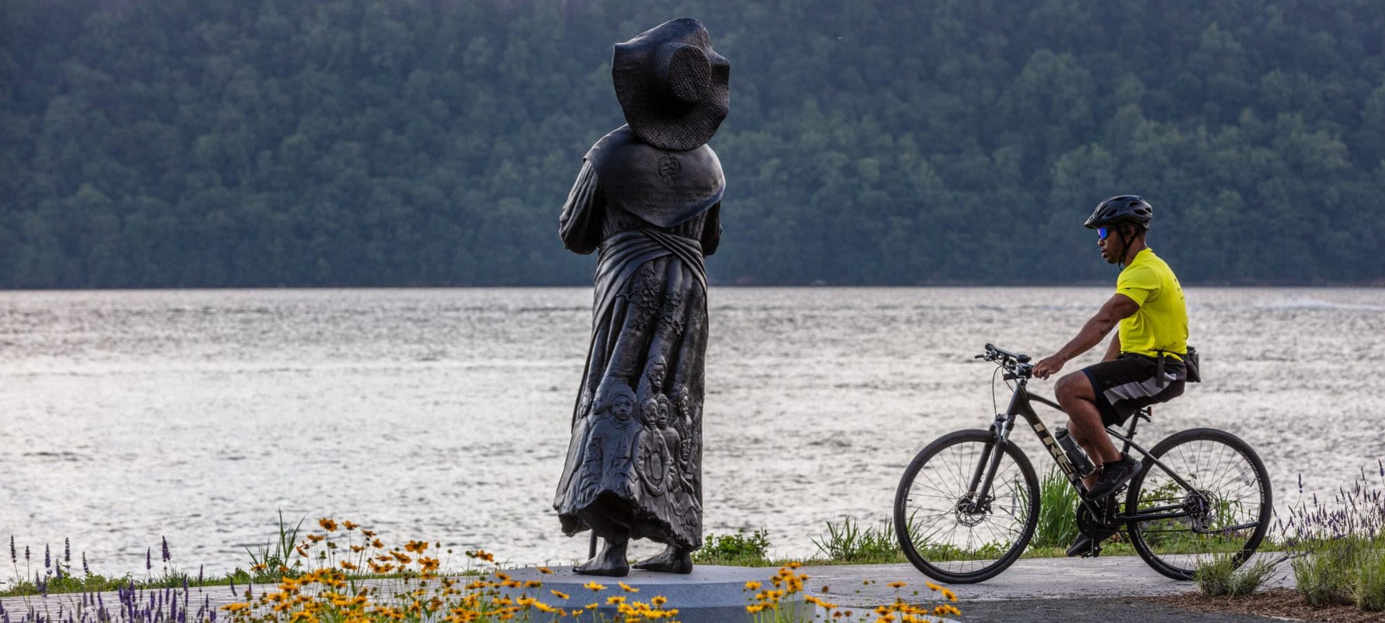 Resident biking length of the river near Alexander Crossing in Yonkers, New York