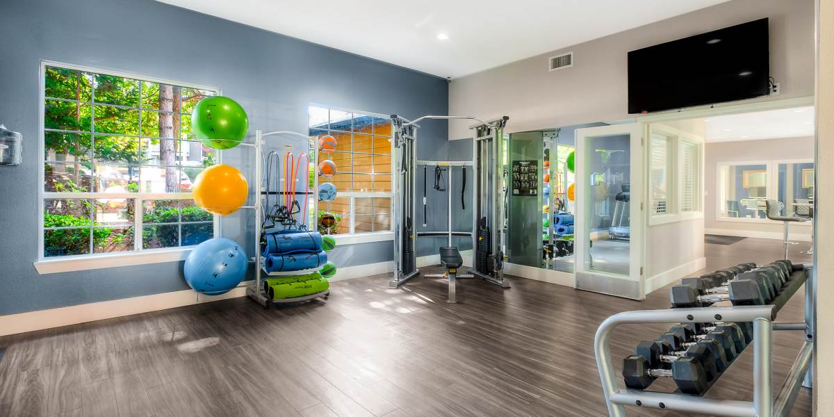 Fitness center with plenty of individual workout stations at Newport Crossing Apartments in Newcastle, Washington