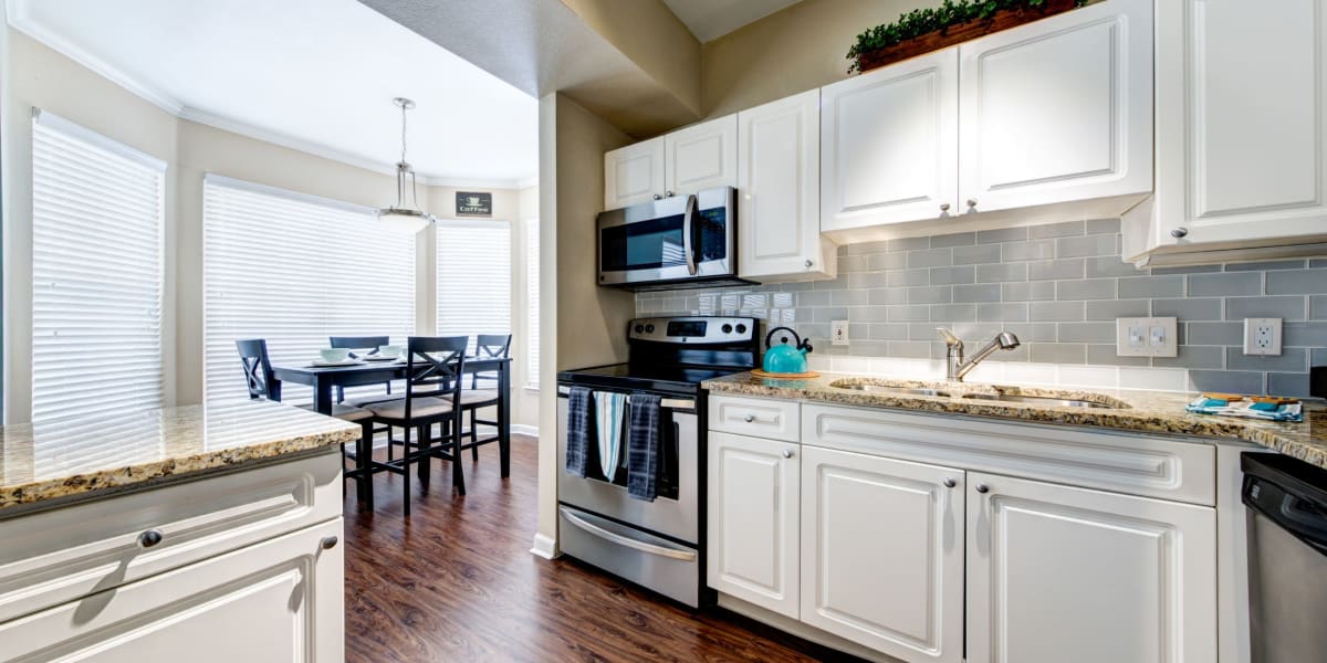 Modern kitchen with white cabinets at Marquis at Town Centre in Broomfield, Colorado